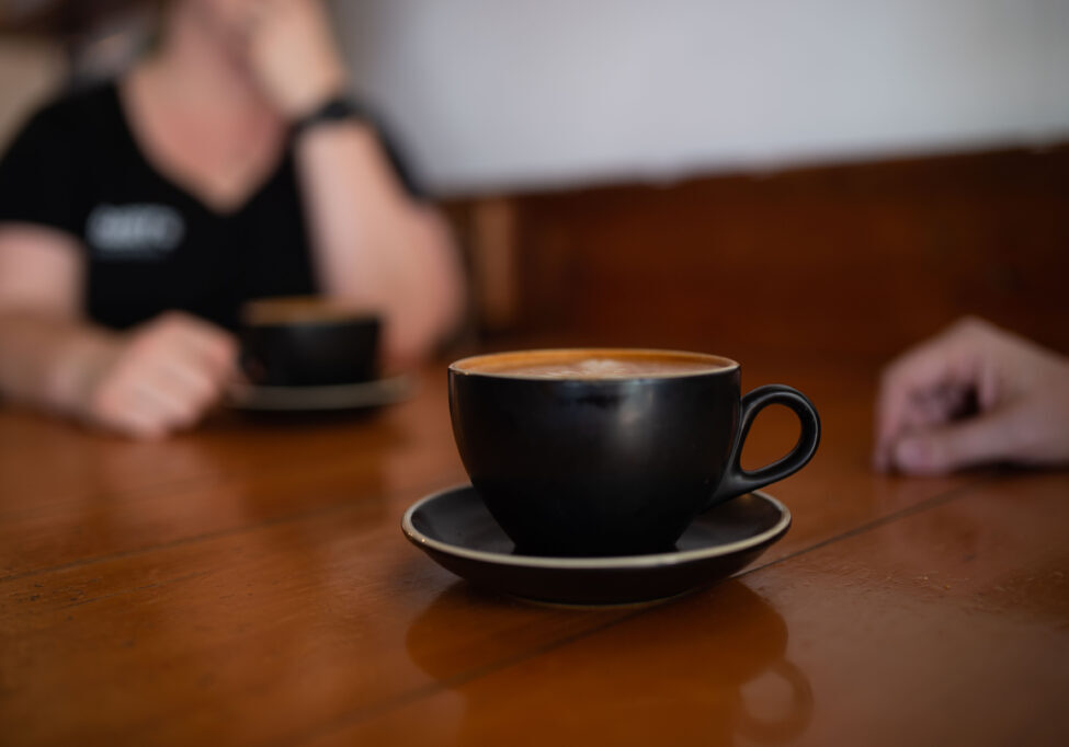 two people talking over coffee