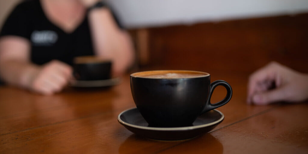 two people talking over coffee